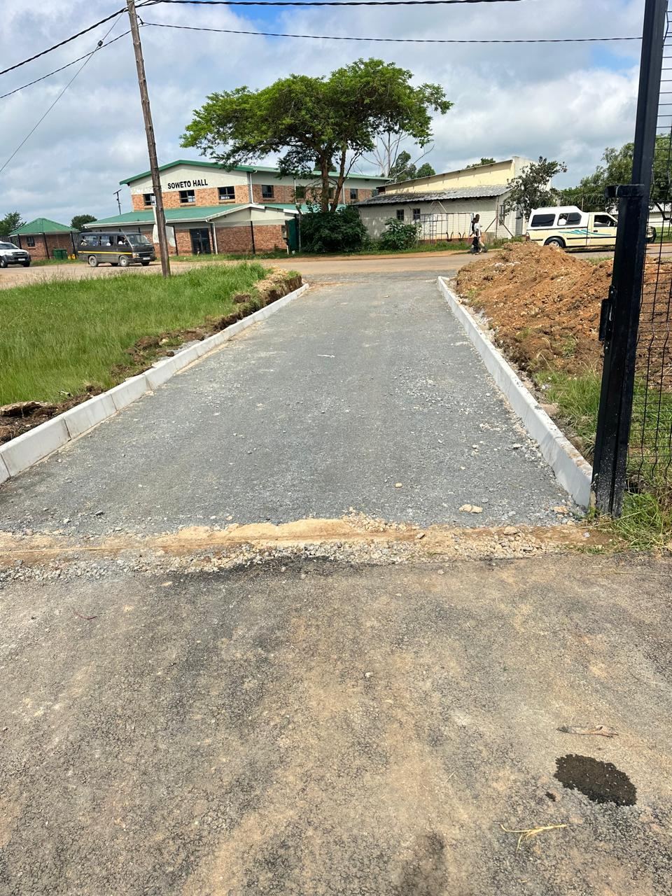 Surfaced access road with new kerbs