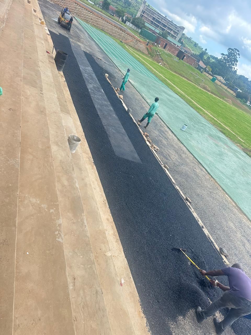 Asphalt being laid on a running track